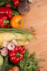 Assortment of fresh raw vegetables on a wooden table. Healthy food Top view background with empty space.
