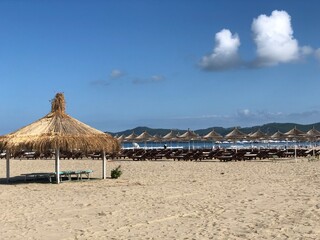 Beach Chairs and Umbrella on a beautiful bach in Durres, Albania.text