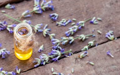 lavender flowers with oil bottle on the wood table in the nature