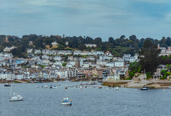 Fototapeta na wymiar shot of the River Dart with Kingswear in the background. Boats on the river Dart in Dartmouth, South Devon. The town of Kingswear can be seen in the background.