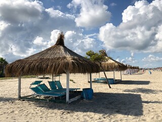 Beach Chairs and Umbrella on a beautiful bach in Durres, Albania.text