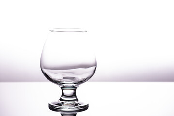 one transparent glass cognac glass isolated on a white background