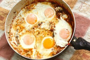 shakshuka - jewish national dish with fried eggs species, tomato, pepper garlic