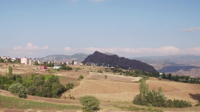 Sebinkarahisar city in north center Turkey in drought mountains landscape. Kalesi Castle. Aerial drone wide view at summer sunny day