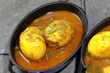 An Indian spread of spicy Egg curry or Egg Masala in a bowl