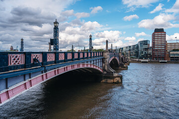 Lamberth bridge on cloudy sunny day with blue sky over the Thames river