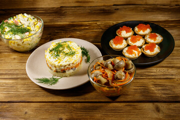 Set of various festive dishes on a wooden table