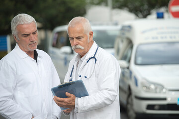 portrait of two successful professional doctors workers in coats