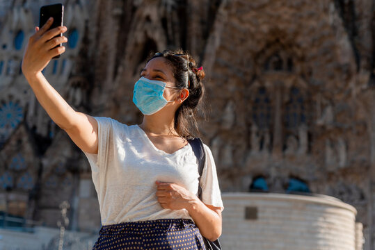 Young Tourist Woman Taking Selfie With Face Mask, Example Of Tourism Industry At The Time Of Covid19. Symbol Of Summer Holidays At The Time Of Corona Virus