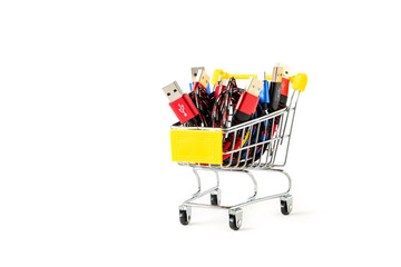 Usb wires for charging phones of different colors in a miniature shopping cart. Purchase of a usb cable.