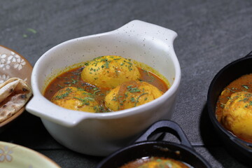 An Indian spread of spicy Egg curry or Egg Masala in a bowl