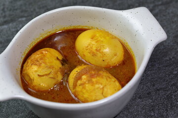 An Indian spread of spicy Egg curry or Egg Masala in a bowl