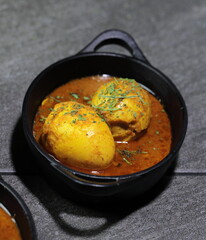 An Indian spread of spicy Egg curry or Egg Masala in a bowl