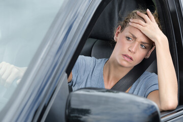 Fototapeta na wymiar impatient female car driver stuck in traffic