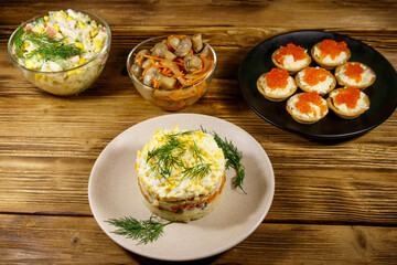 Set of various festive dishes on a wooden table