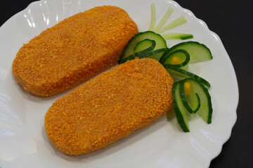 Meat semi-finished, meatballs in breadcrumbs on a white plate.