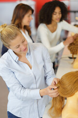 Obraz na płótnie Canvas hairdressing stylish practicing on mannequin