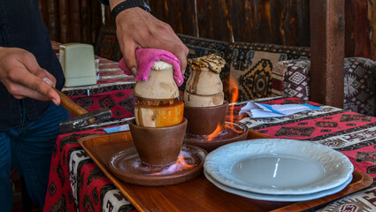 National Turkish dish cooked in a clay pot over fire that is broken before being consumed called Testi kebab.