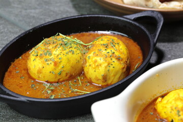An Indian spread of spicy Egg curry or Egg Masala in a bowl