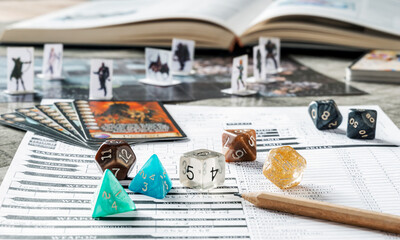 Role playing game set up with dices, board, cards, character sheet and book. RPG concept.