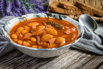 Beans with tomato sauce, bacon and sausage.