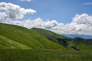 Scenic landscape of Mountain range Chornohora with green slopes in summer day. Carpathian Mountains.