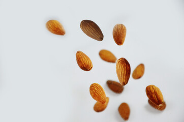 almonds fly on a white background. Composition of nuts flat lay almonds on white background. Concepts about decoration, healthy eating and food background.