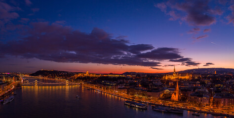 Fototapeta na wymiar Panoramic aerial drone of lighted Matthias Church on Buda Hill by Danube river during Budapest sunset