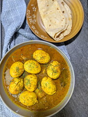 An Indian spread of spicy Egg curry or Egg Masala in a bowl