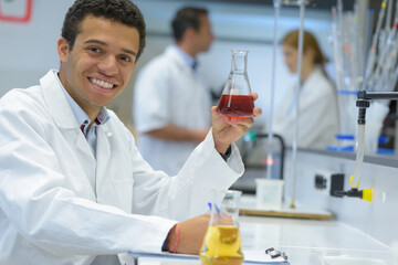 portrait of happy man looking at the medicine dropper