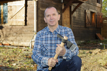 lumberjack with axe resting outdoors