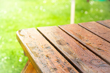 Wet wooden garden table after rain