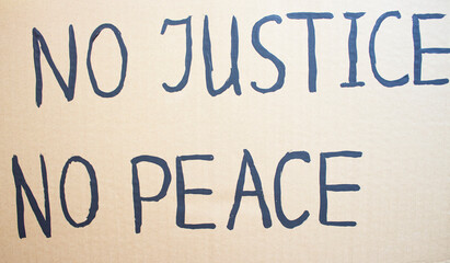 NO JUSTICE NO PEACE. Text message for protest on cardboard. Stop racism. Police violence. Banner Design concept.