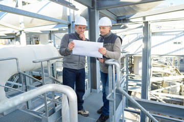 factory engineers studying a plan