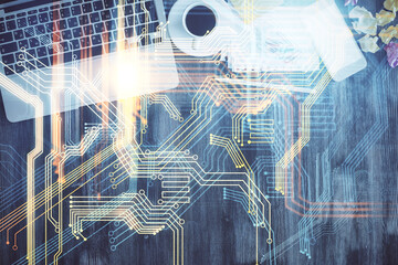 Double exposure of map hologram drawing over study table background with computer. Concept of international network. Top view.