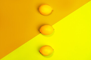 Creative pattern made of lemons on bright yellow background.