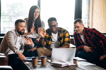 Group video conference. Young successful business team communicates via video conference with their...