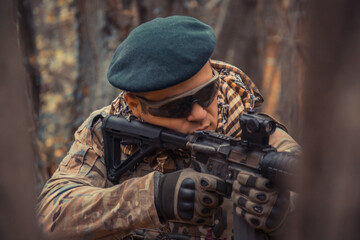 portrait of a soldier with a gun in the forest of Battlefield/army uniform with a weapon.