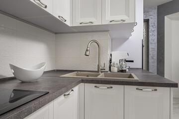 Closeup of minimalistic white kitchen furniture