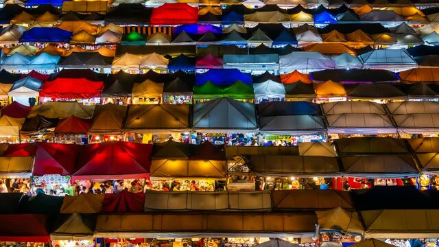 time lapse Top view of Train Night Market Ratchada (Talad Rot Fai). market with plenty of shops with colorful canvas roofs at night in Bangkok, Thailand