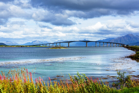 concrete bridge with harbor in background, shot under bright summer light at Stokmarknes, Hadseloya, Vesteralen, Norway
