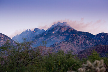 Distant Bighorn fire and smoke on peaks of Catalina Mountains at sunrise