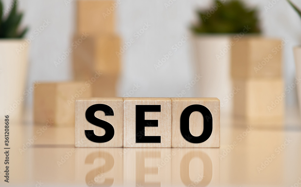 Poster search engine optimization concept. wooden block cube shape with word seo and laptop