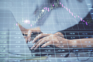 Multi exposure of woman hands typing on computer and financial graph hologram drawing. Stock market...