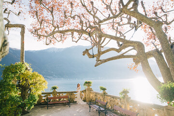 Wedding Bride with veil and white wedding dress on villa Balbianello lake Como in Italy