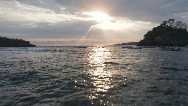 Sun Beaming from Sky and Reflecting on the Beautiful Ocean Waters in Indonesia