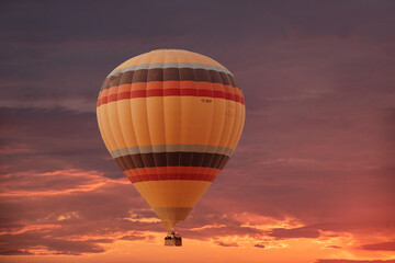 Evening sky background with white dramatic clouds and hot air balloon