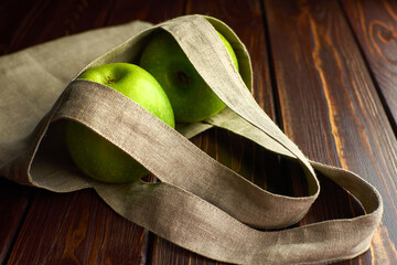 Apples in reusable linen shopping bag. Zero waste shopping, recycling concept, eco-friendly...