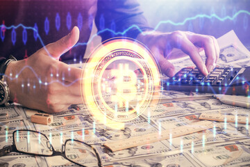 Double exposure of man's hands holding and using a phone and crypto currency blockchain theme...