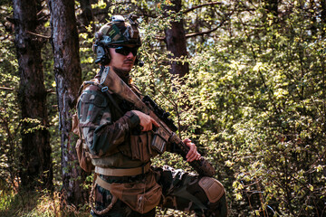 	
Soldier in a forest hiding in a foliage. Full equipment. soldier concept	
